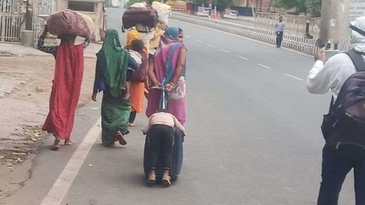 NHRC takes cognisance of migrant woman walking on Agra highway pulling her child sleeping half hung on suitcase