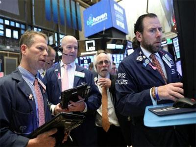 Wall Street surges on hints of fewer rate hikes, dollar falls
